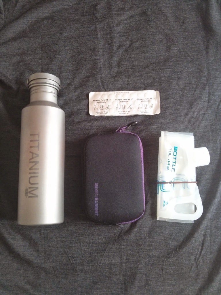Clockwise: Vargo titanium water bottle, Katadyn Micropur Forte tablets, Platypus Plus 1L bottle, and Sea to Summit padded pouch (M) Clockwise: Vargo titanium water bottle, Katadyn Micropur Forte tablets, Platypus Plus 1L bottle, and Sea to Summit padded pouch (M)