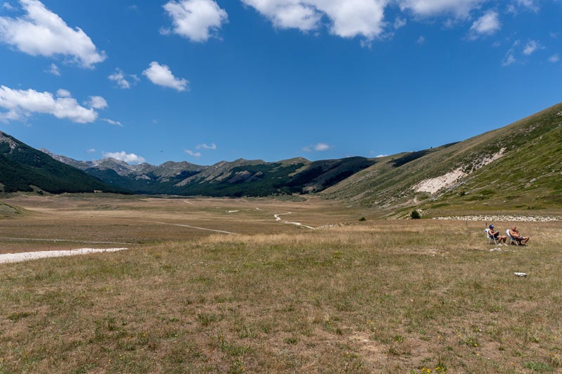 photo of Abruzzo landscape with couple relaxing in sun chairs