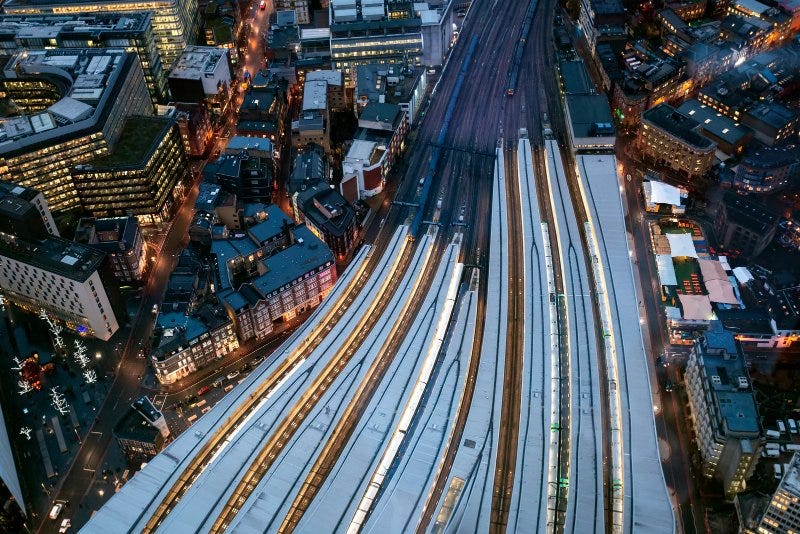 Aerial view of railway tracks merging into a city station Aerial view of railway tracks merging into a city station