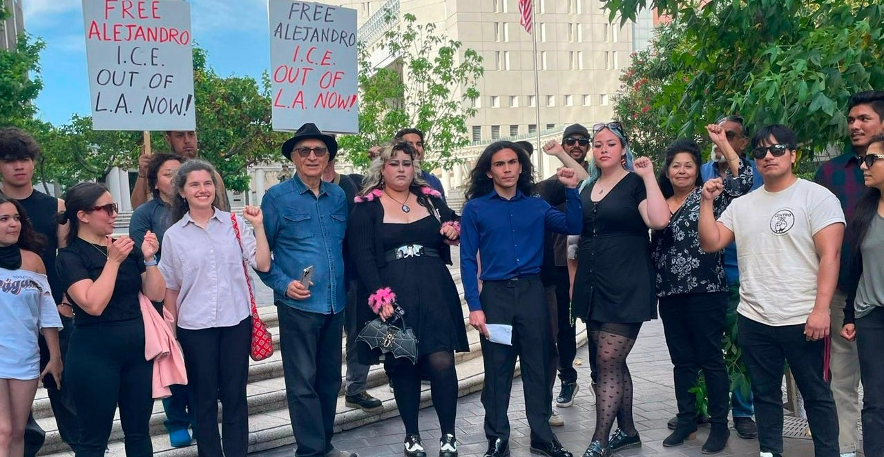 Alejandro Orellana with fist raised \[center\] after his release.