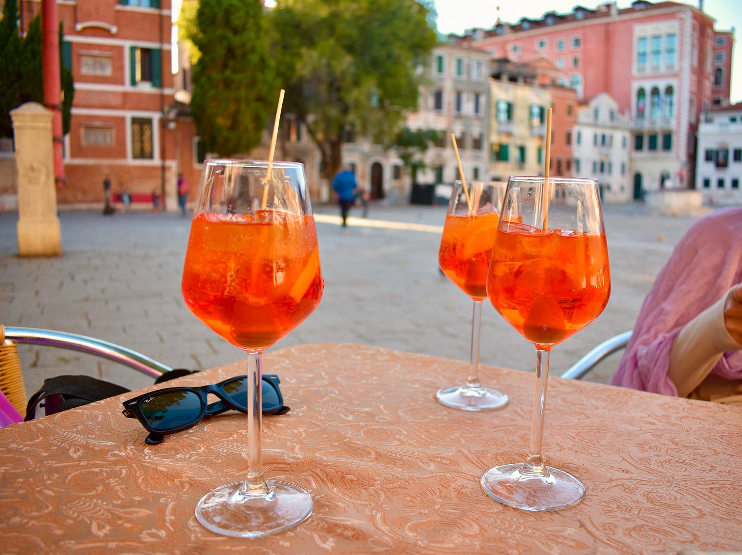3 aperol spritz on a table in Venic