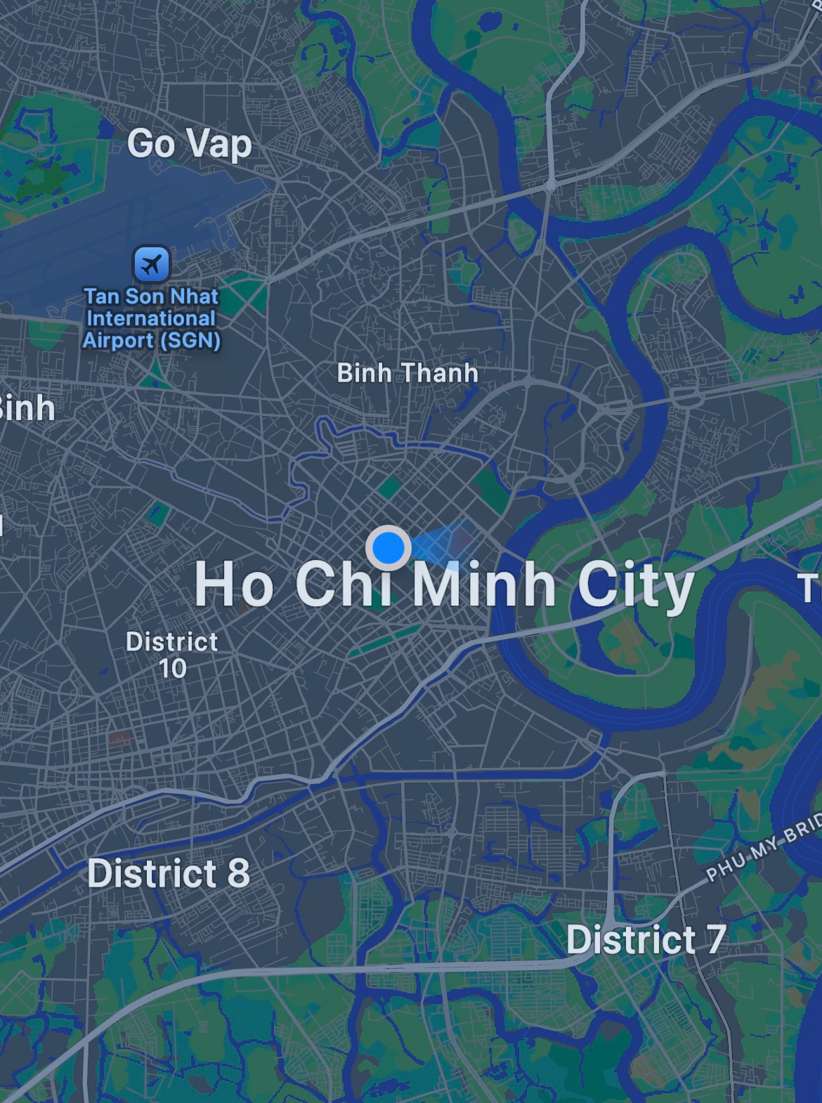 Dark-mode map of Ho Chi Minh City, Vietnam, showing a blue location dot near the city center, surrounding districts (Binh Thanh, District 10, District 7, District 8, Go Vap), the Saigon River, and Tan Son Nhat International Airport (SGN). Dark-mode map of Ho Chi Minh City, Vietnam, showing a blue location dot near the city center, surrounding districts (Binh Thanh, District 10, District 7, District 8, Go Vap), the Saigon River, and Tan Son Nhat International Airport (SGN).