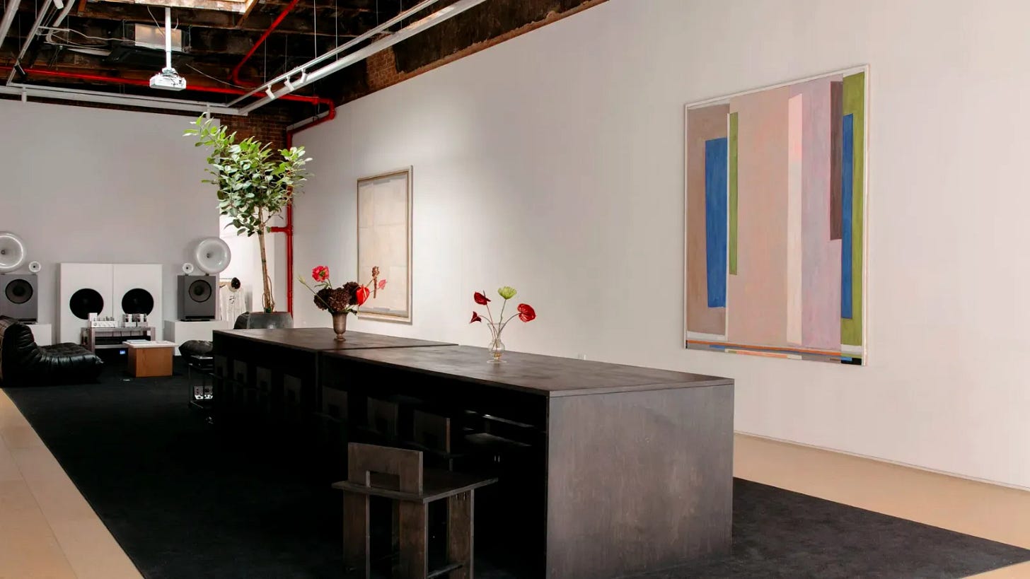 Interior of Silence Please listening room and cafe on the Bowery in Manhattan, showing minimalist workspace with handmade speakers and ambient lighting