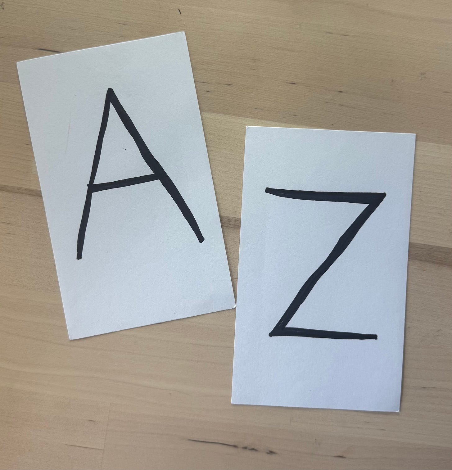 Handwritten capital letters A and Z on white index cards