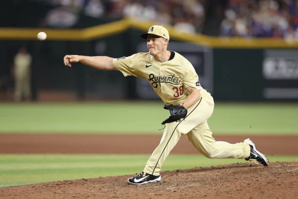 Relief pitcher Paul Sewald of the Arizona Diamondbacks pitches against the Los Angeles Dodgers during the seventh inning of the MLB game at Chase...