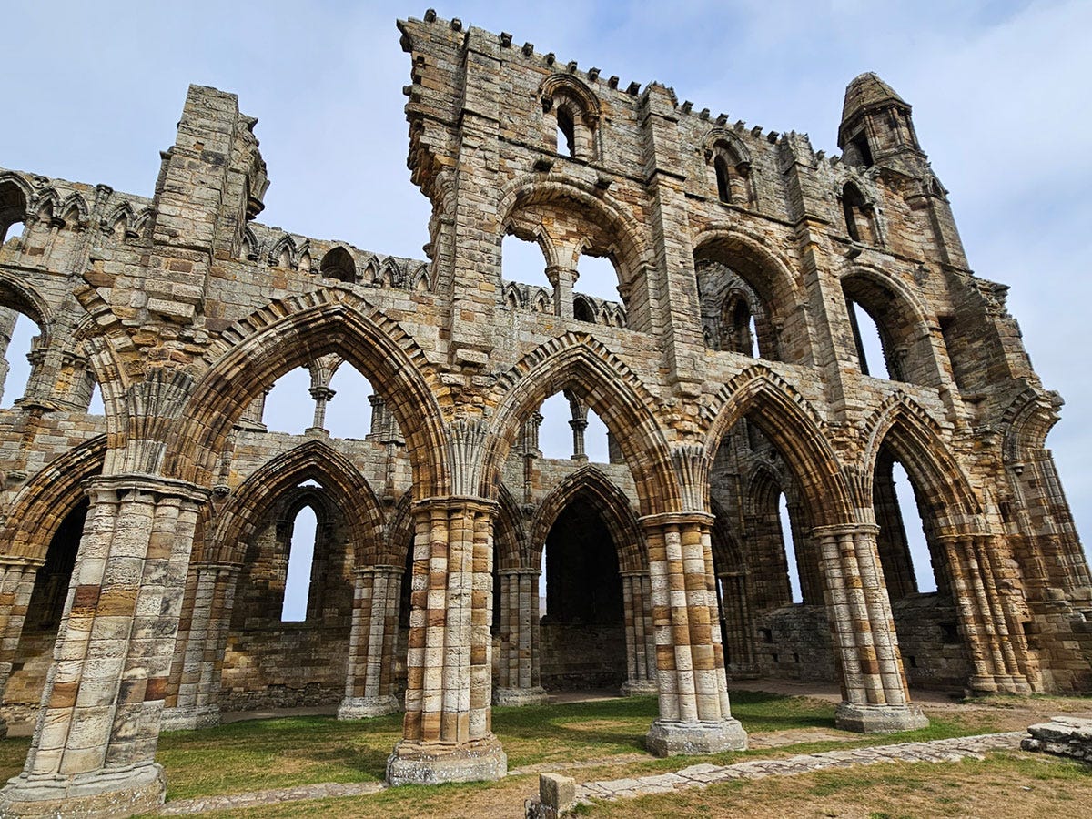 View from the side of a ruined building, with an open roof and crumbling walls