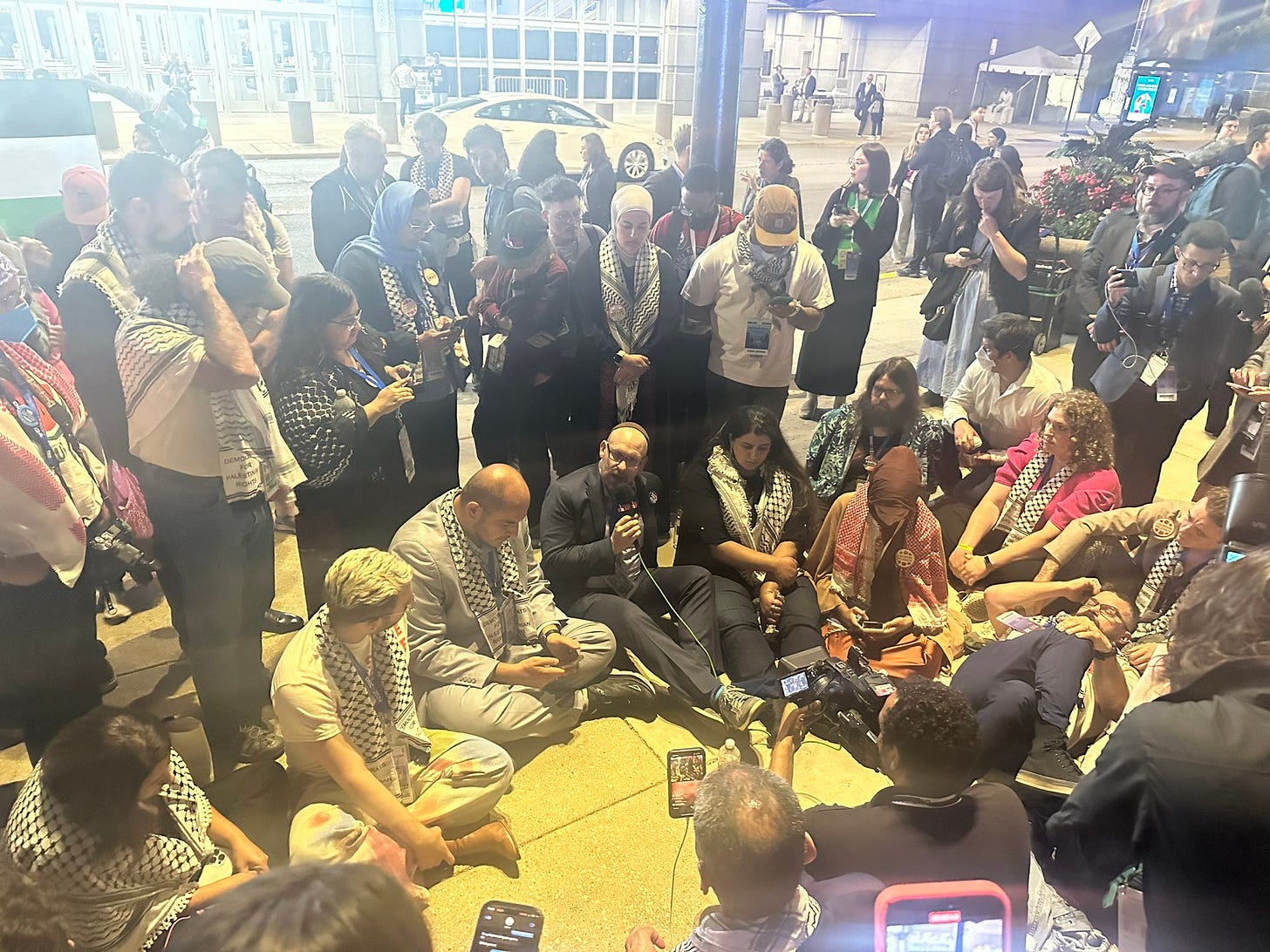 A group of protestors sitting outside the DNC A group of protestors sitting outside the DNC