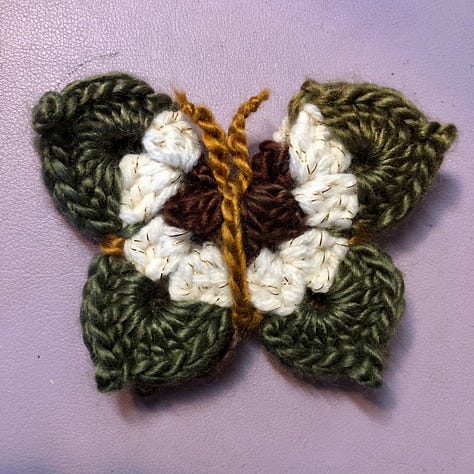 Nine multi-coloured crocheted butterflies