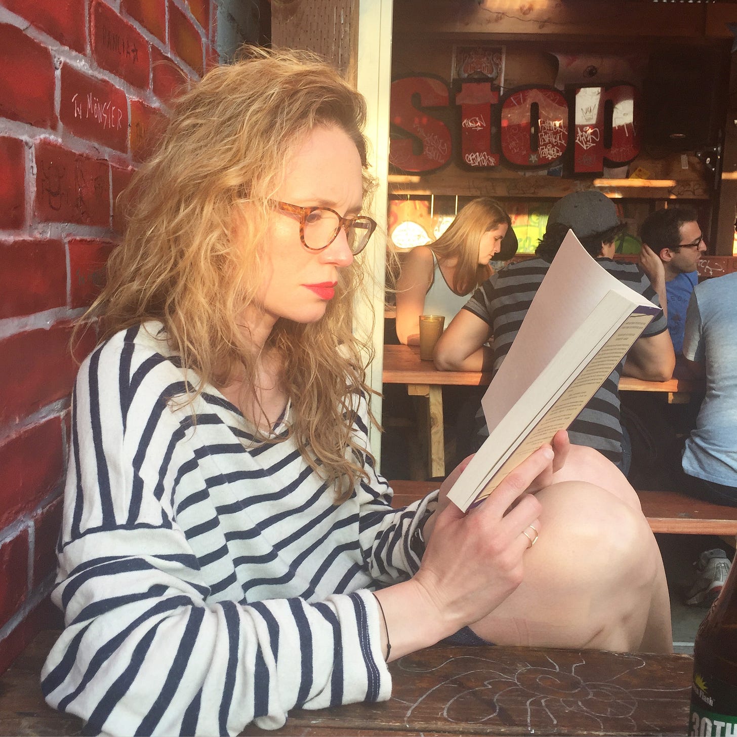 I am reading at a bar with red lipstick