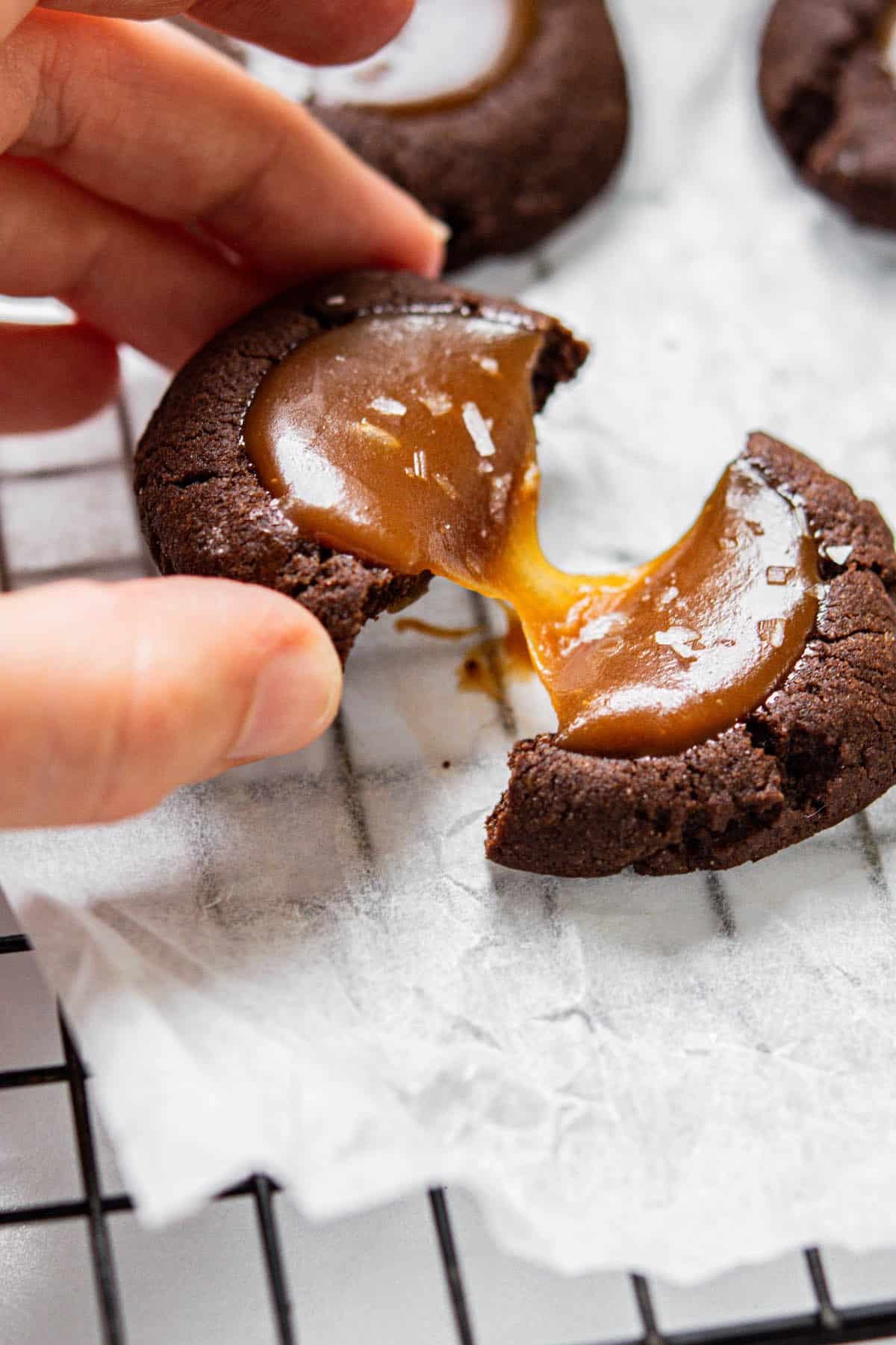 hand holding a caramel filled cookie.