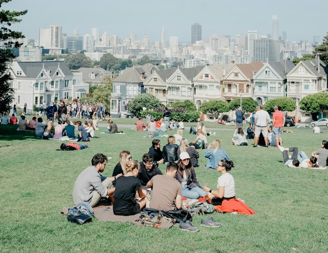 people sitting on grass field during daytime people sitting on grass field during daytime
