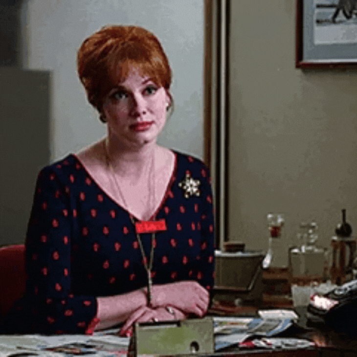 Woman sitting at a desk rolling her eyes. Woman sitting at a desk rolling her eyes.