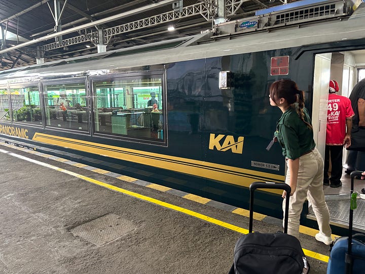 Train attendant working Panoramic class on the train from Yogyakarta to Surabaya, Indonesia, and lunch served at seats