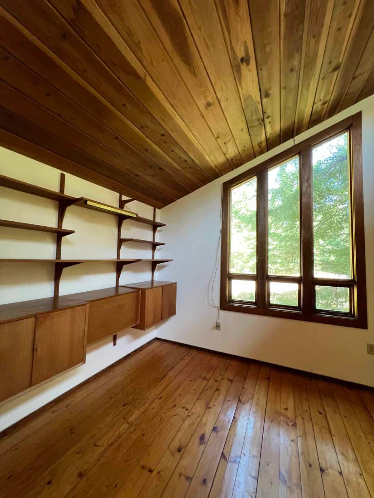 dark damaged hardwood pine  floors before sanding them to a light finish.
