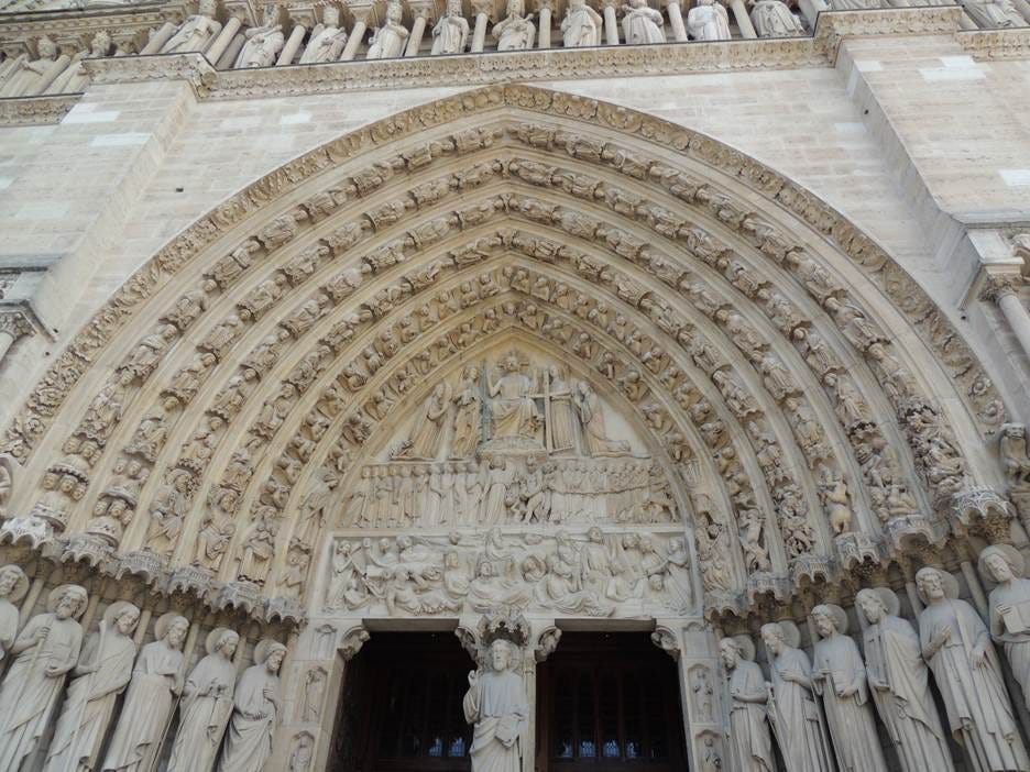A stone archway with statues on the front

AI-generated content may be incorrect.