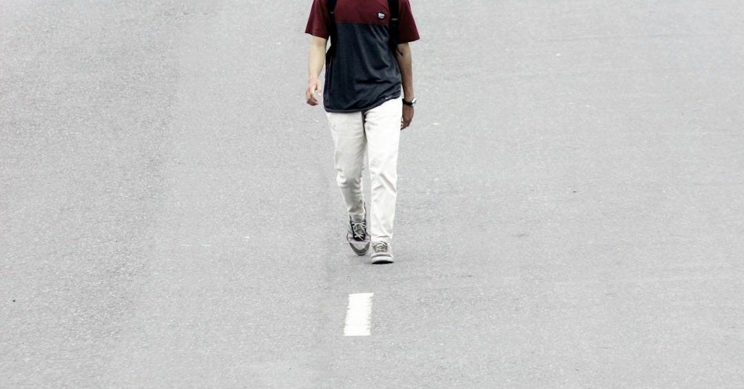 man walking on road at daytime man walking on road at daytime