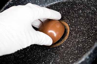 Melt edges of hot chocolate bomb sphere Melt edges of hot chocolate bomb sphere