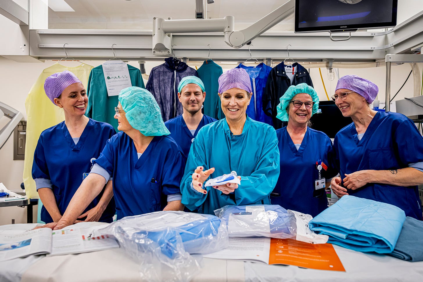 Queen Maxima and medical personnel wearing scrubs