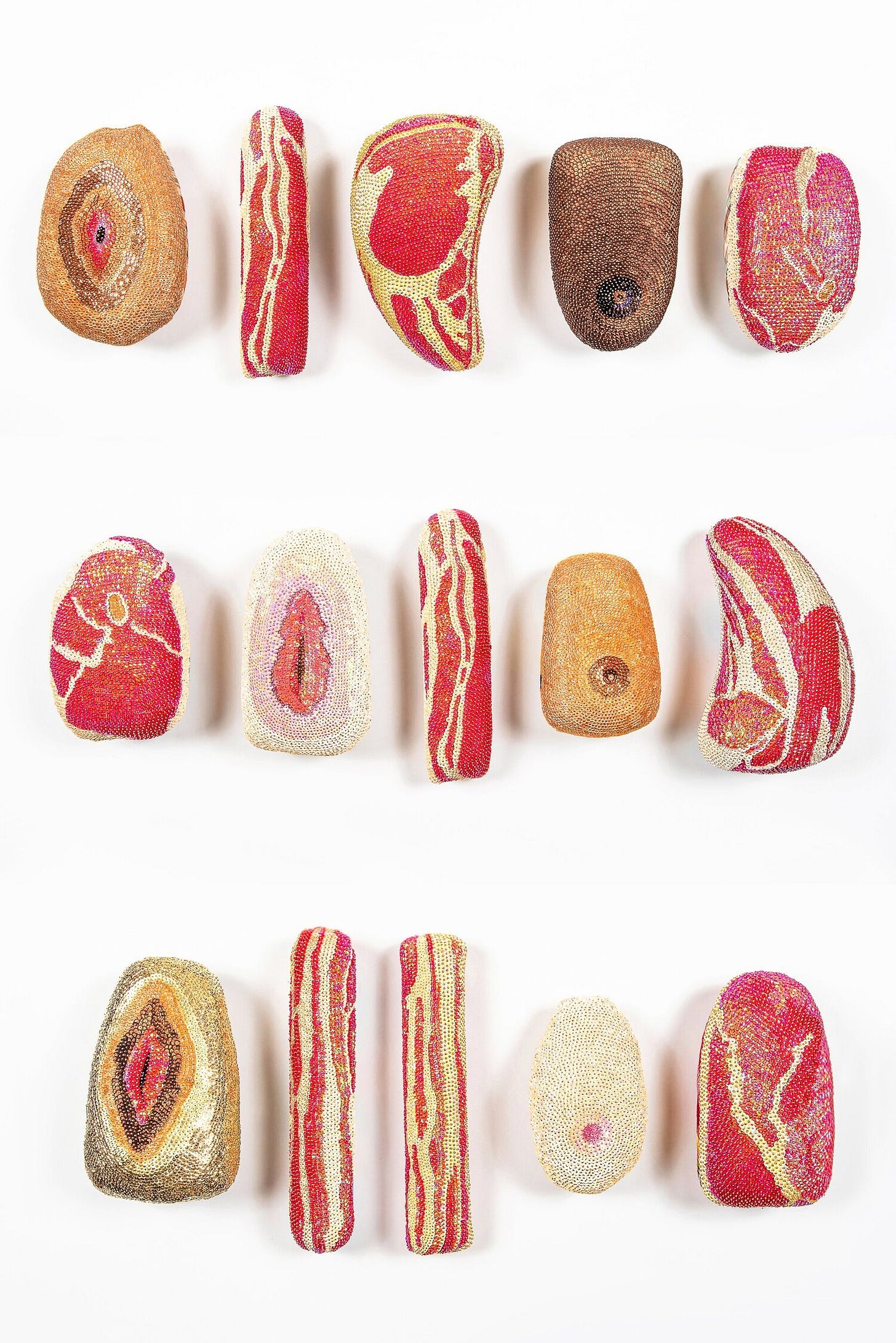 fifteen sequined shapes floating against a white background. The long, skinny ones are sequined to look like slabs of bacon. The shapes that are wider at the top and narrower at the bottom are sequined to look like cuts of steak. The oval forms are sequined to look like either breasts or vulva, with varying skin tones. fifteen sequined shapes floating against a white background. The long, skinny ones are sequined to look like slabs of bacon. The shapes that are wider at the top and narrower at the bottom are sequined to look like cuts of steak. The oval forms are sequined to look like either breasts or vulva, with varying skin tones.