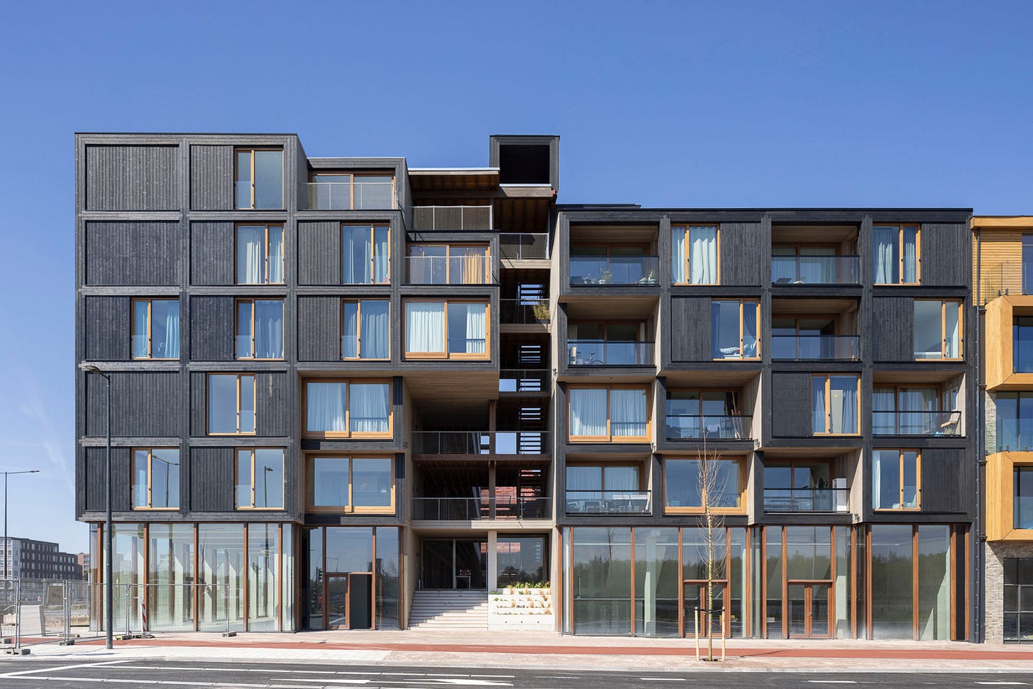 Black timber modular homes with glass balconies