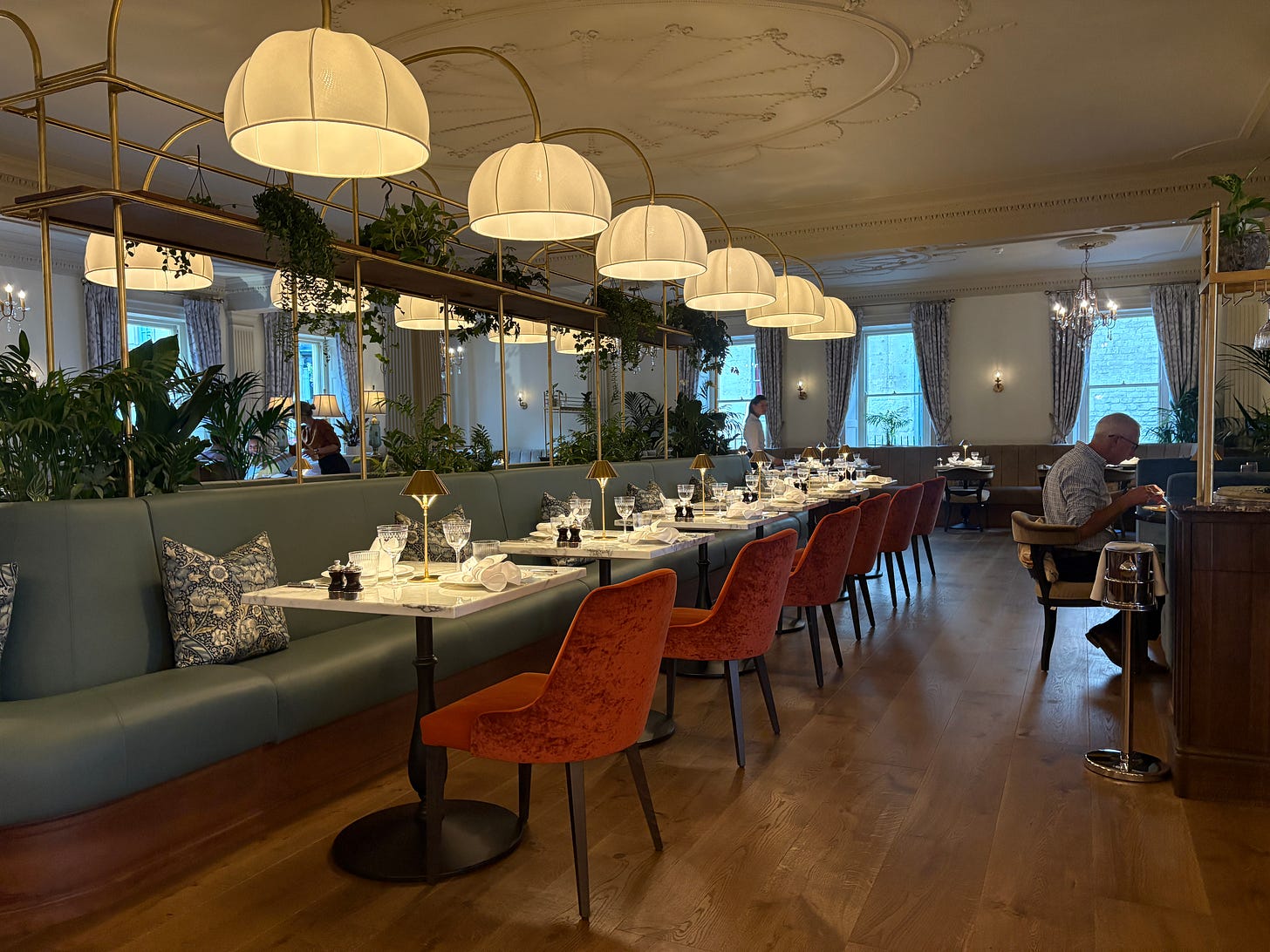 Luxurious armchairs and leather booths are lit by grandiose chandeliers at Emberwood Luxurious armchairs and leather booths are lit by grandiose chandeliers at Emberwood