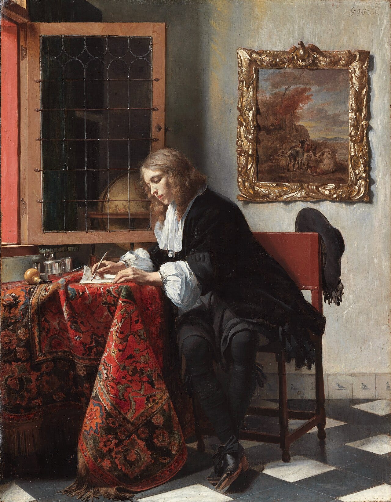 A young man writing a letter by a bright window A young man writing a letter by a bright window