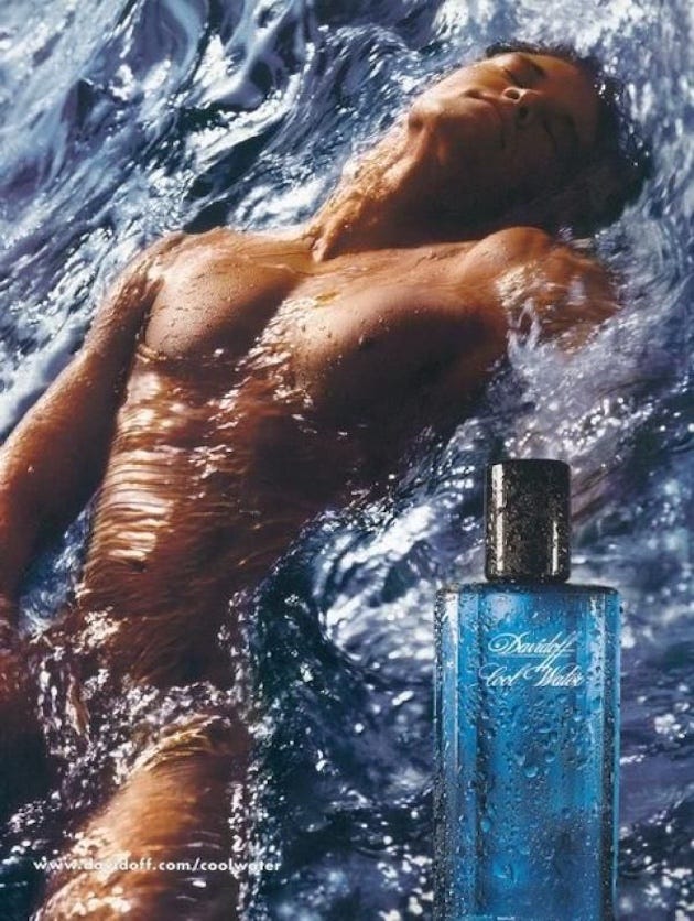 A vintage advertisement for Davidoff Cool Water cologne featuring a shirtless man reclining in swirling ocean water with his eyes closed, body slick and glistening. In the foreground, a blue bottle of Cool Water is shown upright, covered in droplets. The image evokes sensuality, fluidity, and elemental masculinity. A vintage advertisement for Davidoff Cool Water cologne featuring a shirtless man reclining in swirling ocean water with his eyes closed, body slick and glistening. In the foreground, a blue bottle of Cool Water is shown upright, covered in droplets. The image evokes sensuality, fluidity, and elemental masculinity.