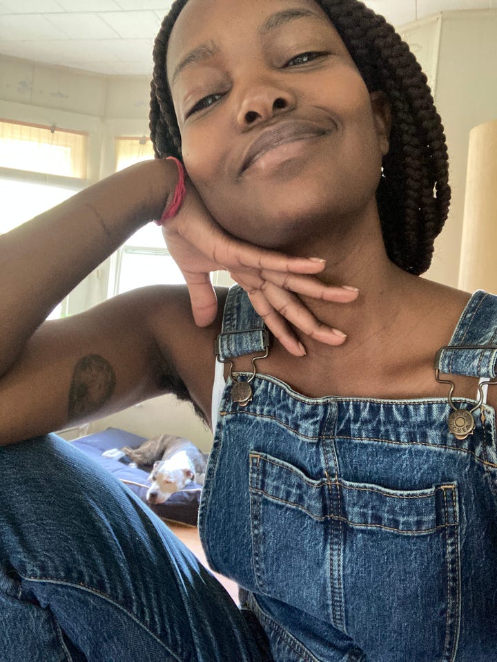 Left: A brown-skinned woman with her braids pulled back takes a selfie in front of a large, rectangular mirror with an ornate gold frame. The mirror reflects a room with a Rosie-dog sleeping on the floor and a window overlooking a yard. Right: A brown-skinned woman with her hair pulled back into a braid. Her left hand is under her chin. The crook of her arm-pit and her upper thigh create a frame against a Rosie-dog, seen laying on a bed in the background.