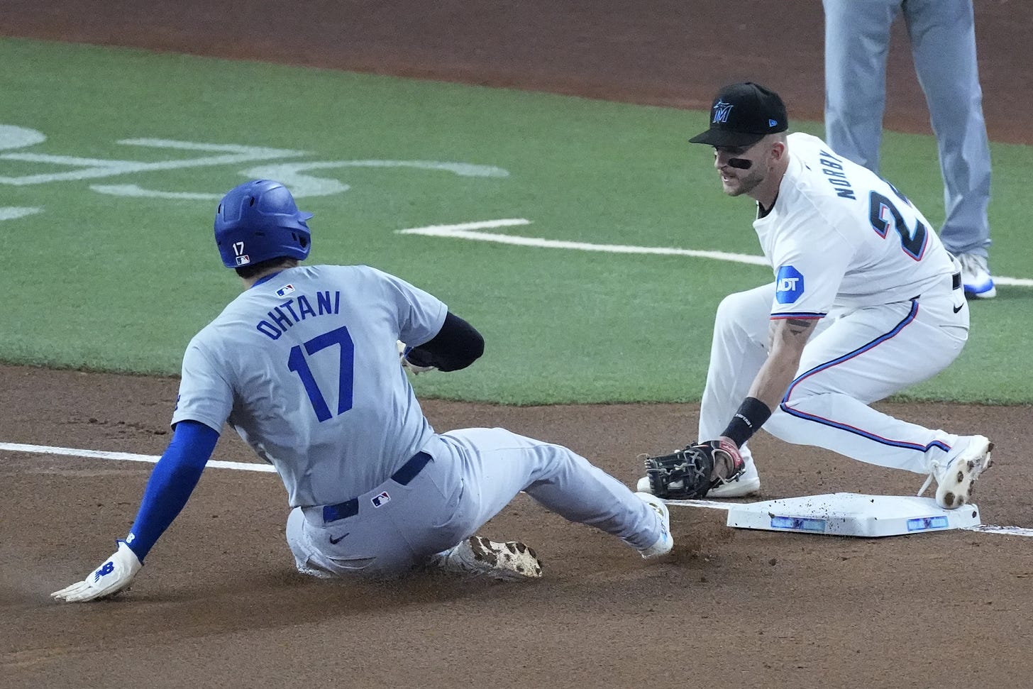 Shohei Ohtani (17) of the Los Angeles Dodgers steals his 50th base of the season as Miami Marlins third baseman Connor Corby tries to tag him in the Dodgers versus Marlins contest on September 19, 2024 (Photo: Associated Press/Wilfredo Lee). Shohei Ohtani (17) of the Los Angeles Dodgers steals his 50th base of the season as Miami Marlins third baseman Connor Corby tries to tag him in the Dodgers versus Marlins contest on September 19, 2024 (Photo: Associated Press/Wilfredo Lee).