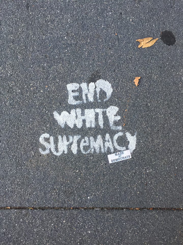 both photos are of spray painted words on the side walk. The first one reads, "Women Deserves Pockets" and the second one says, "End White Supremacy"