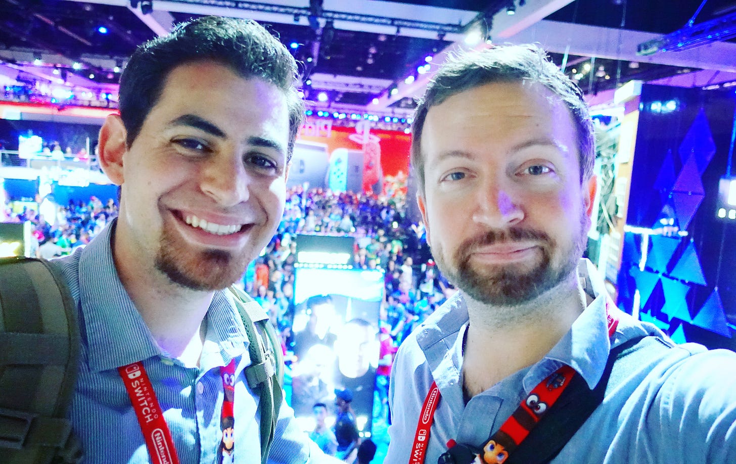 Next-gen video games owner and Matt Swider attending E3. Tons of people in the background on the show floor Next-gen video games owner and Matt Swider attending E3. Tons of people in the background on the show floor
