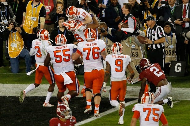 Wide receiver Hunter Renfrow #13 of the Clemson Tigers celebrates with teammates after making a 2-yard game-winning touchdown reception against defensive back Tony Brown #2 of the Alabama Crimson Tide during the fourth quarter of the 2017 College Football Playoff National Championship Game at Raymond James Stadium on January 9, 2017 in Tampa, Florida. (Photo by Brian Blanco/Getty Images) Wide receiver Hunter Renfrow #13 of the Clemson Tigers celebrates with teammates after making a 2-yard game-winning touchdown reception against defensive back Tony Brown #2 of the Alabama Crimson Tide during the fourth quarter of the 2017 College Football Playoff National Championship Game at Raymond James Stadium on January 9, 2017 in Tampa, Florida. (Photo by Brian Blanco/Getty Images)
