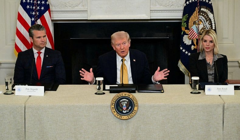 President Donald Trump, flanked by Defense Secretary Pete Hegseth (left) and Attorney General Pam Bondi, speaks during a law enforcement roundtable at the White House in Washington, D.C., October 23, 2025. President Donald Trump, flanked by Defense Secretary Pete Hegseth (left) and Attorney General Pam Bondi, speaks during a law enforcement roundtable at the White House in Washington, D.C., October 23, 2025.