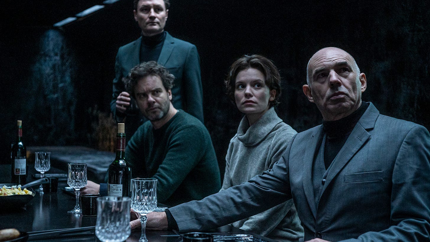 Film still from NR. 10 with characters at a dinner table looking off-screen. Film still from NR. 10 with characters at a dinner table looking off-screen.