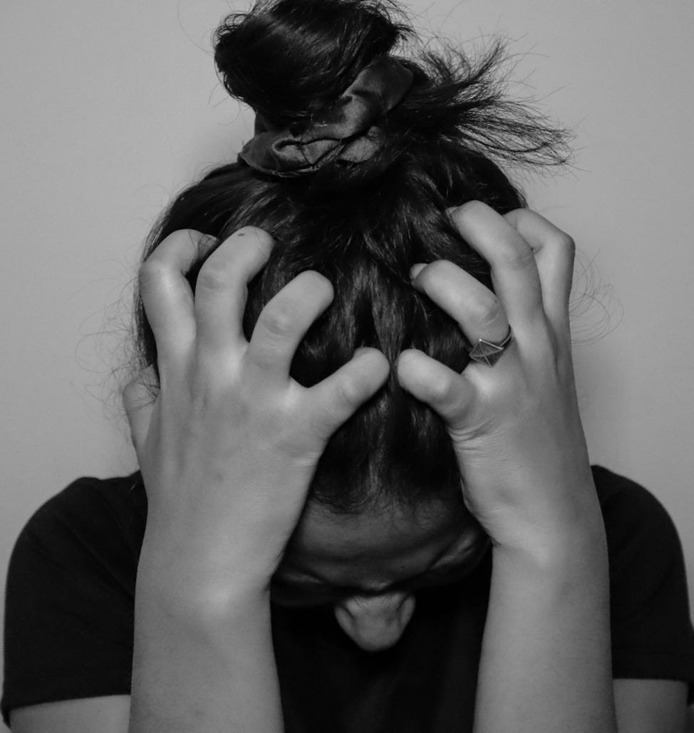 a woman covering her face with her hands