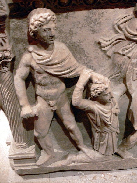 Color photograph of a relief sculpture. A semi-nude figure is dragging another by his hair. Color photograph of a relief sculpture. A semi-nude figure is dragging another by his hair.