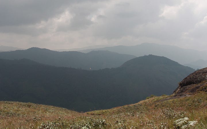 Images of mountains with cloudy skies, mostly grassland with some forest and bare rock.
