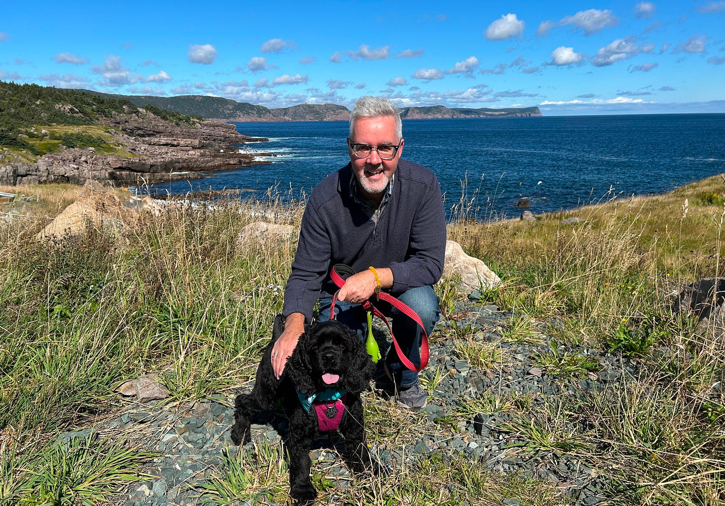 Joe with Cocker Spaniel overlooking coast of Newfoundland