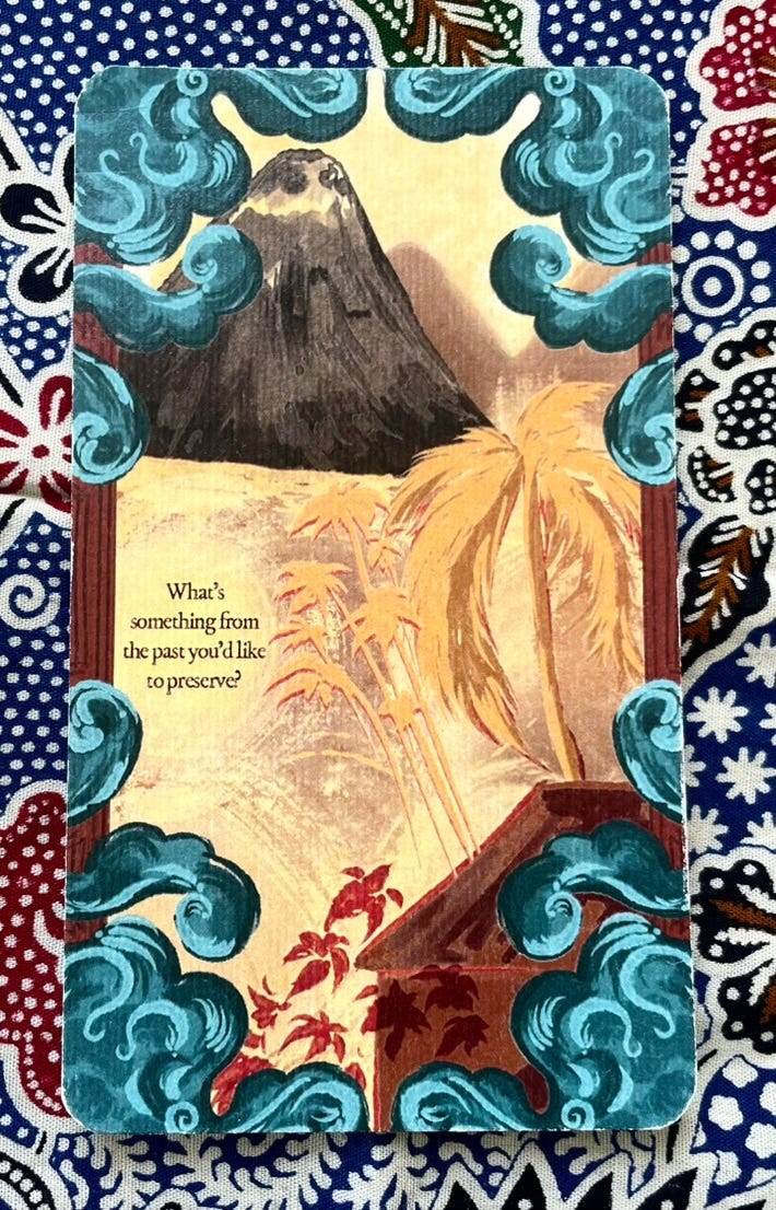 Card with volcano and palm tree with text: "What's something from the past you'd like to preserve?"