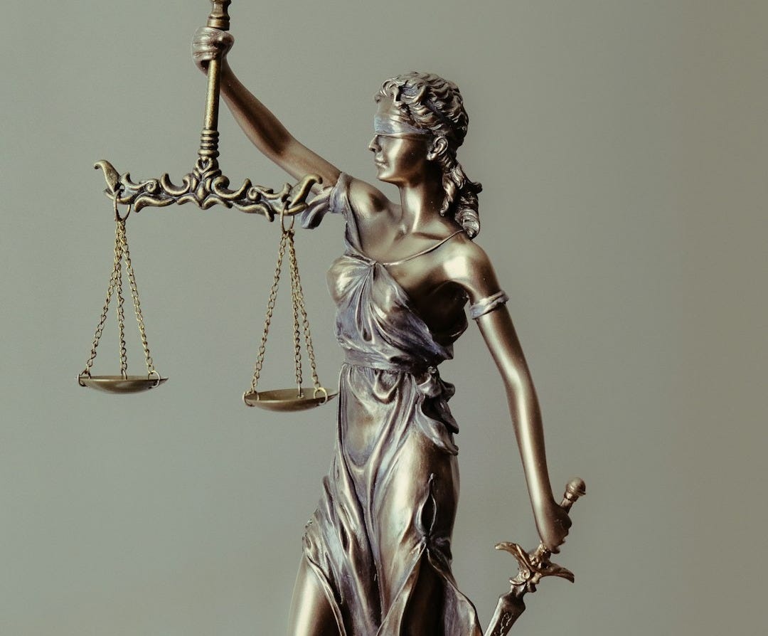 woman in gold dress holding sword figurine