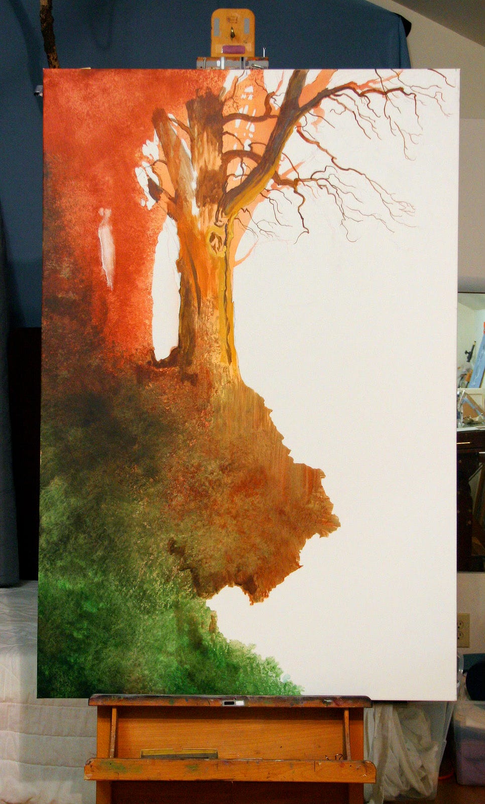 Photo of RISING as a work in progress. The underpainting top left is russet color and lower left is green. The forking branches of the tree have been defined against the contrast of white blank canvas as is the earthy overhang against what is to be sky.