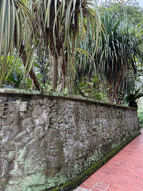 rooster, cement carvings, trees, walking paths through a park