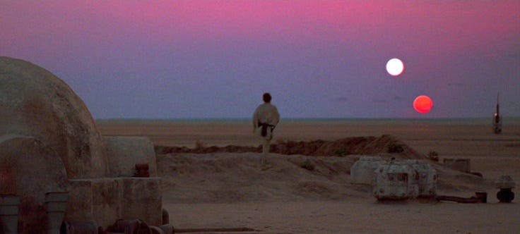 This may contain: the sun is setting in the distance over some desert land and people are walking around