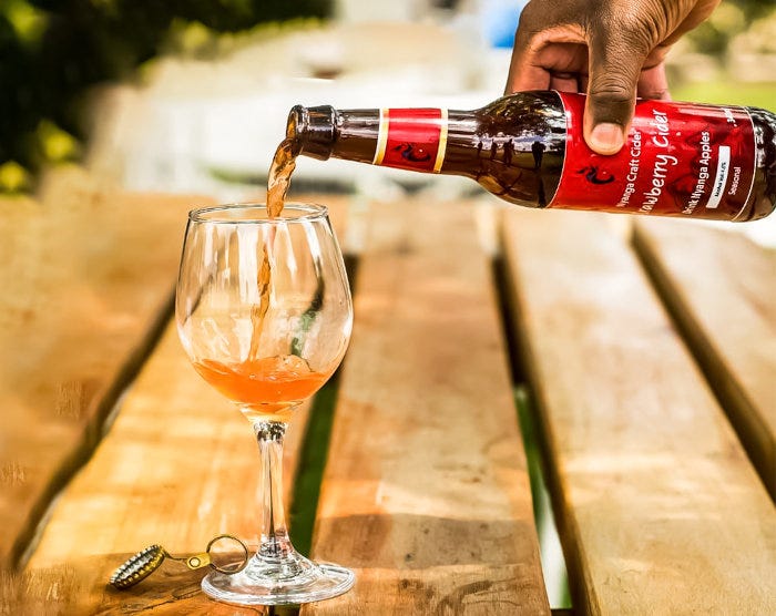 A bottle of Nyanga Craft Cider being poured into a glass.