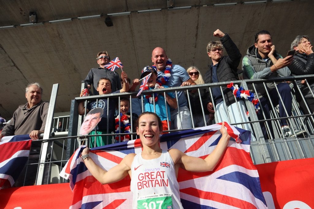 A person holding a flag and a crowd of people

AI-generated content may be incorrect.