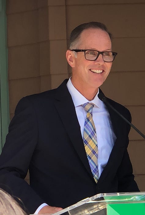 Ribbon Cutting, Chris Slama, and a mom and chld inside the library
