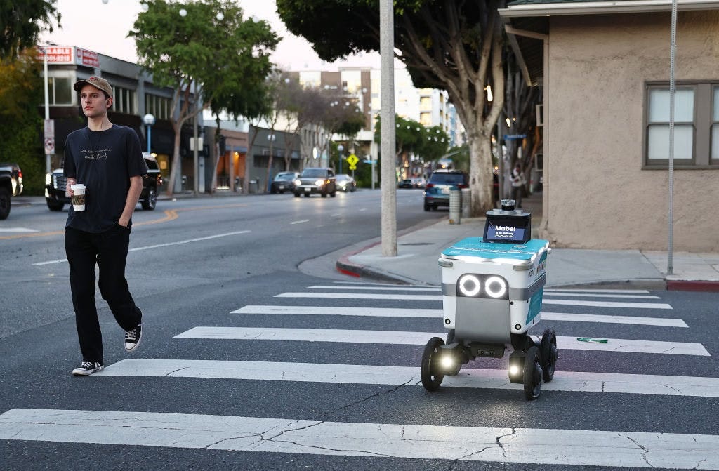 A Serve robot crossing the street