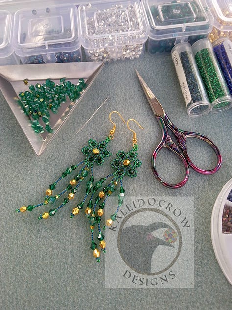 Sparkly dangly beaded earrings in a peach/gold color and a green/gold color.
