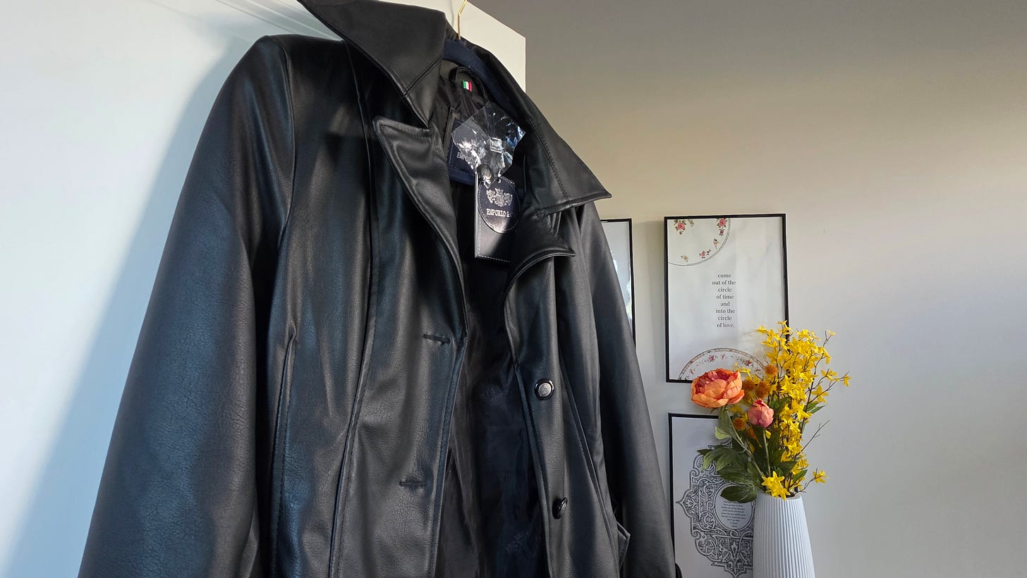 black jacket hanging on hanger black jacket hanging on hanger