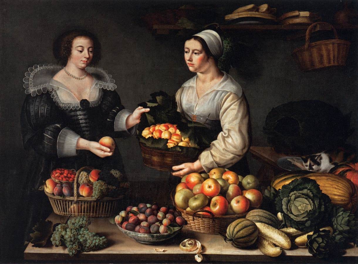 A market woman offers fruit to a customer beside baskets of produce in soft light A market woman offers fruit to a customer beside baskets of produce in soft light